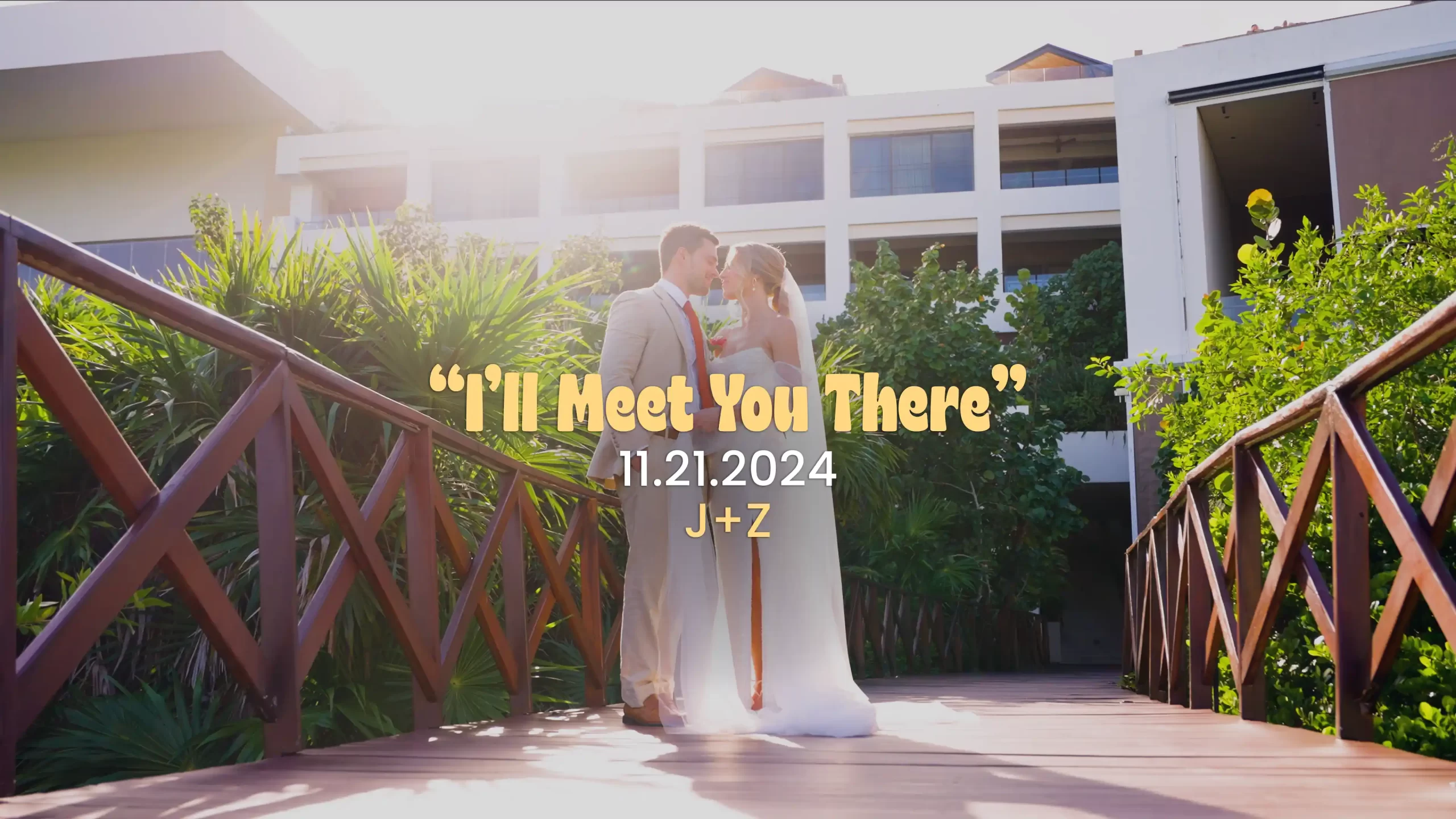 A Atelier Playa Mujeres wedding couple poses on the path with sunlight behind